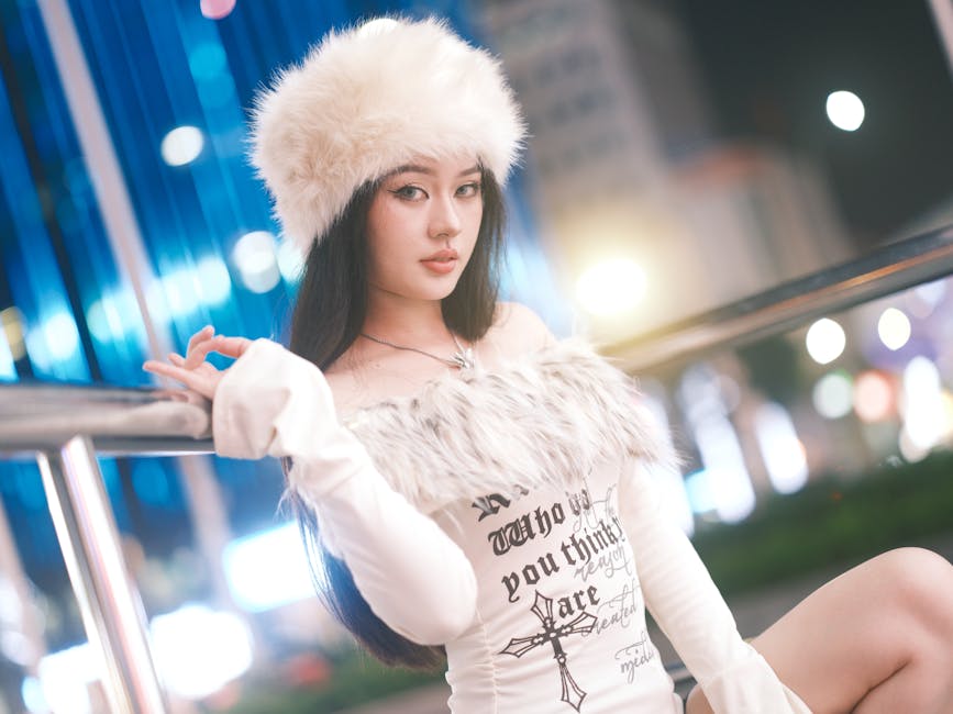 Stylish woman posing in winter fashion with city lights in the background, Vietnam setting.