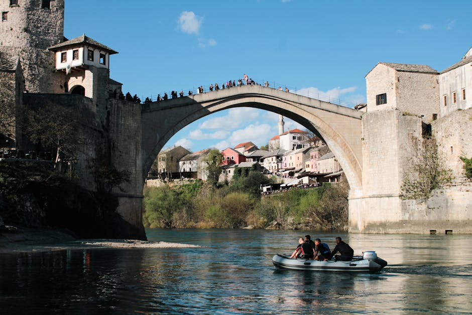 Tourists enjoy a boat ride near the historic Stari Most bridge in Mostar, Bosnia and Herzegovina.